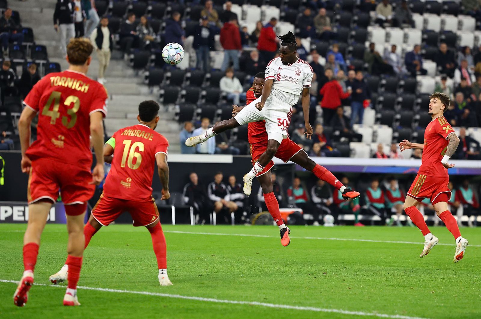 Jeremie Frimpong rises above a LASK defender to head the ball toward goal